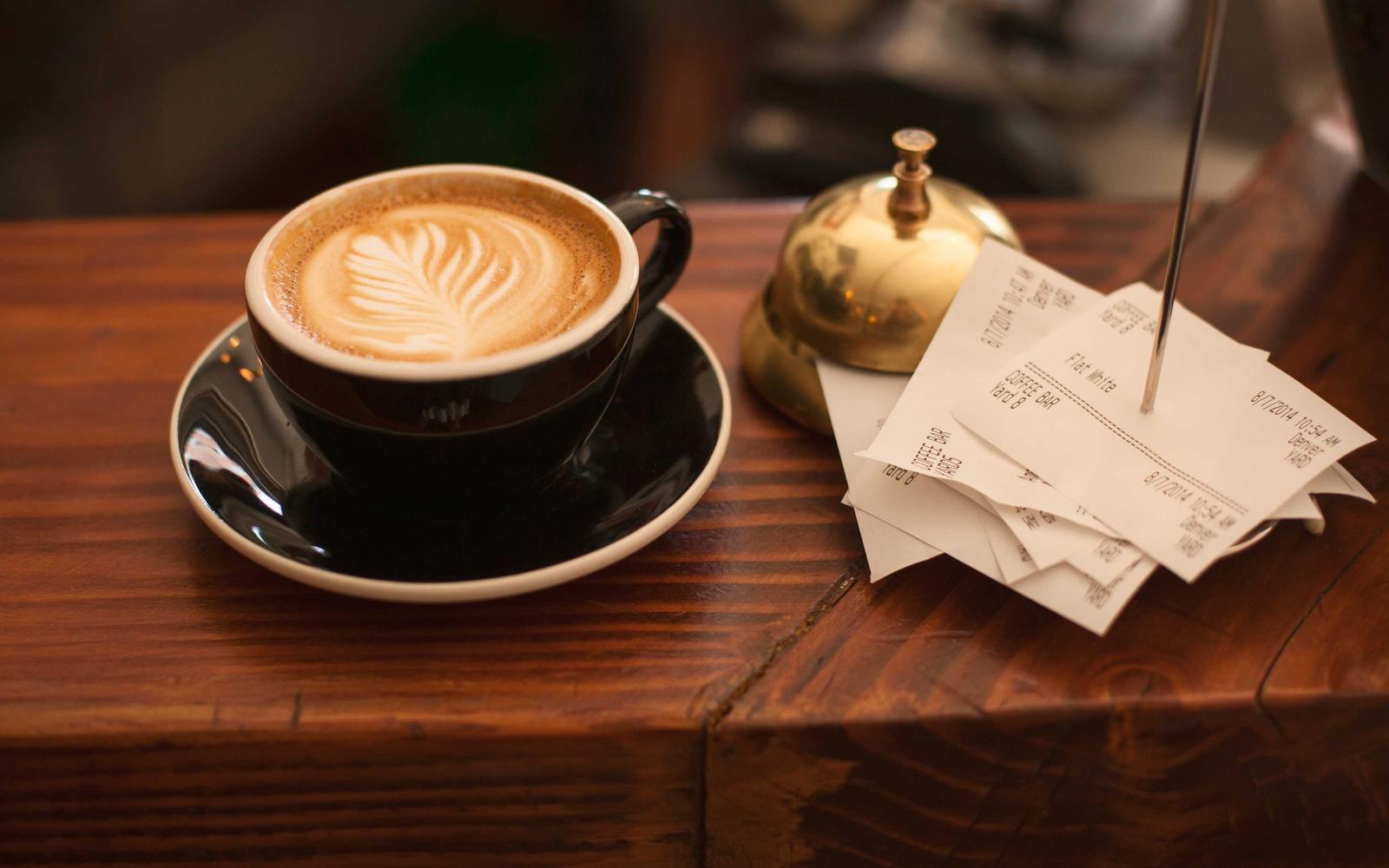 A coffee on a wooden table by a window